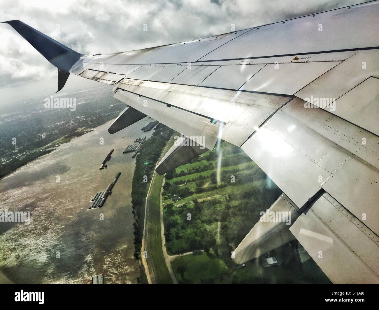 Plane wing above the Mississippi river in Louisiana - Smartphone Captured Stock Image