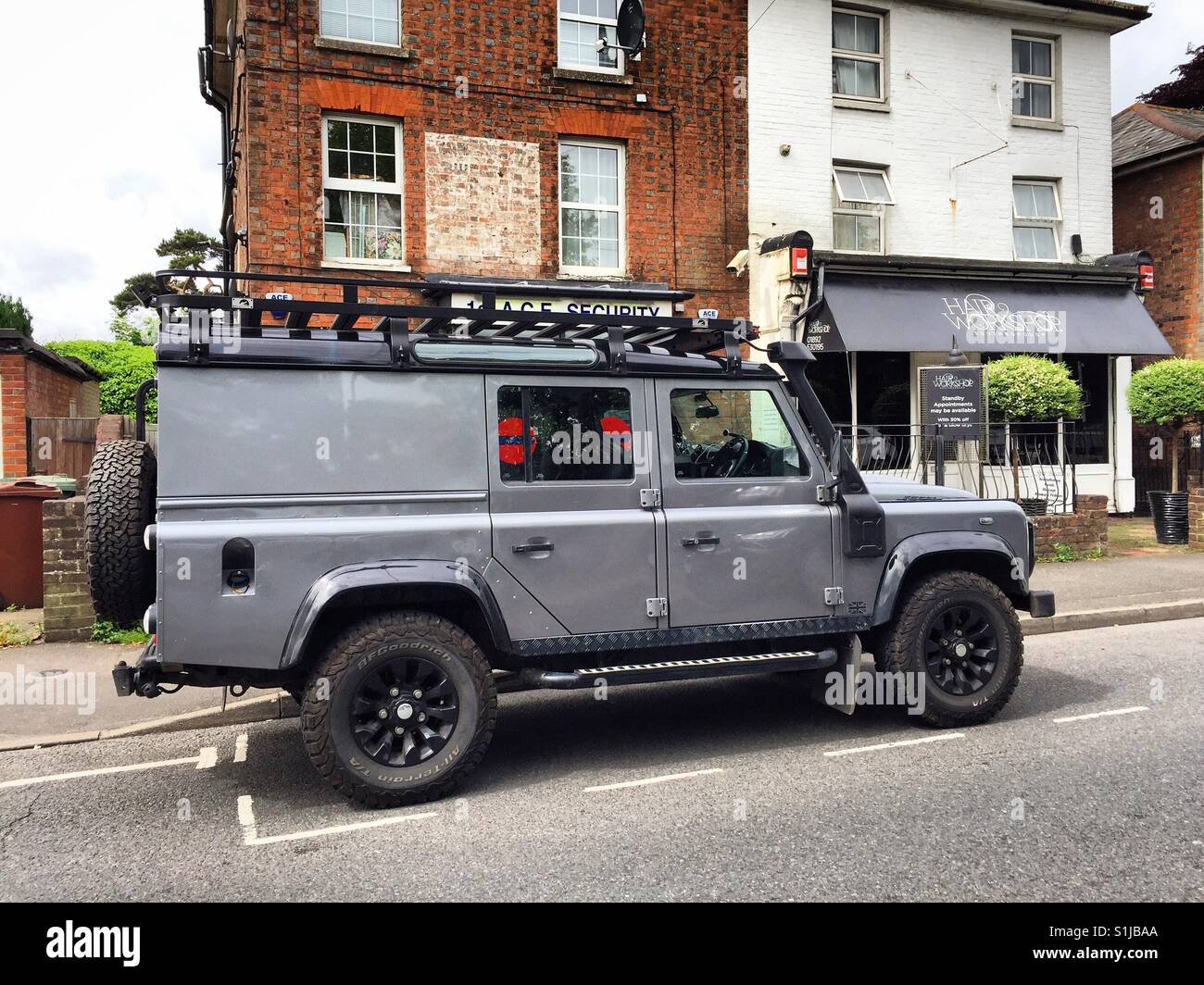 Land Rover Defender 110 parked on the street. Stock Photo