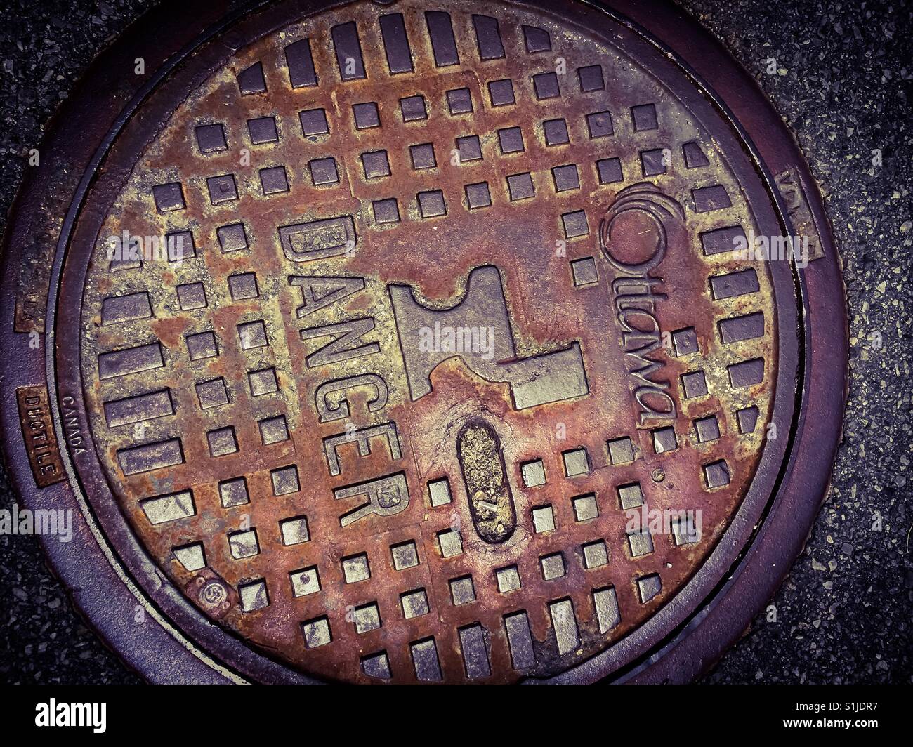 Sewer cover with toilet icon - Smartphone Captured Stock Image