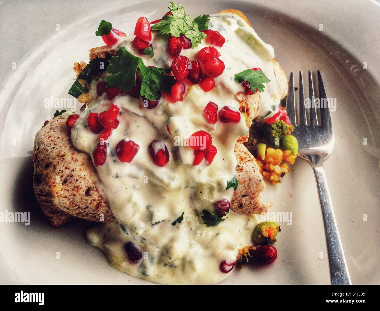 Spinach falafel wrap with pomegranate seedsfrom Waitrose cafe Stock Photo