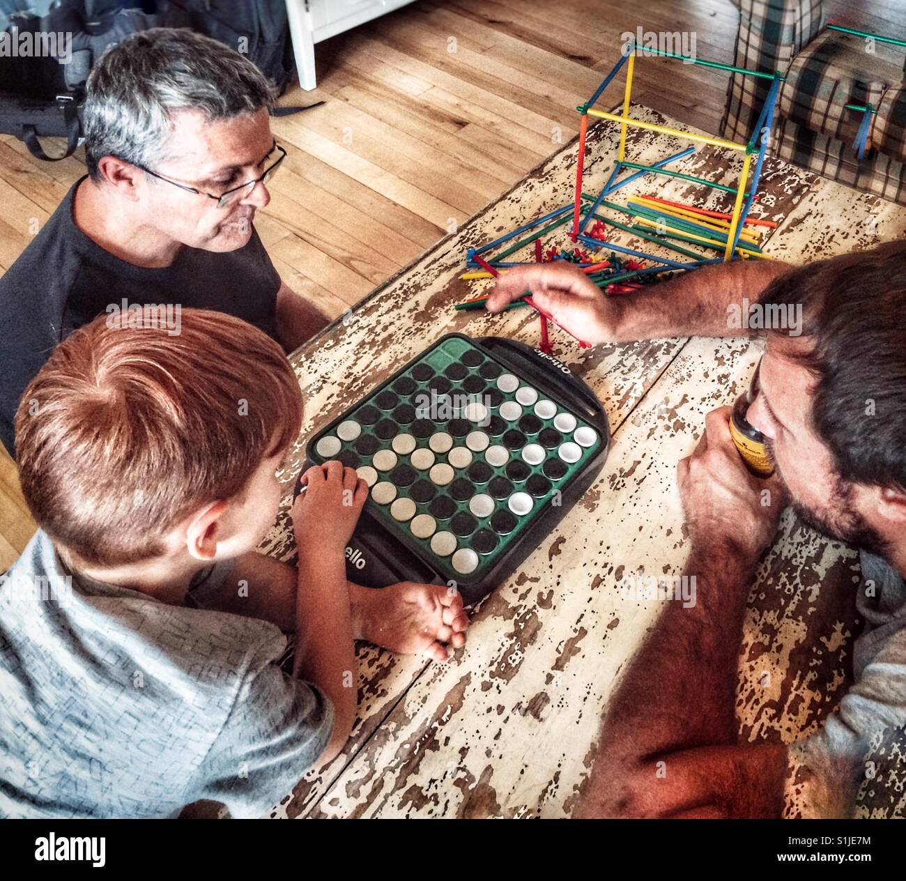 Three generations playing games at the cottage. Stock Photo