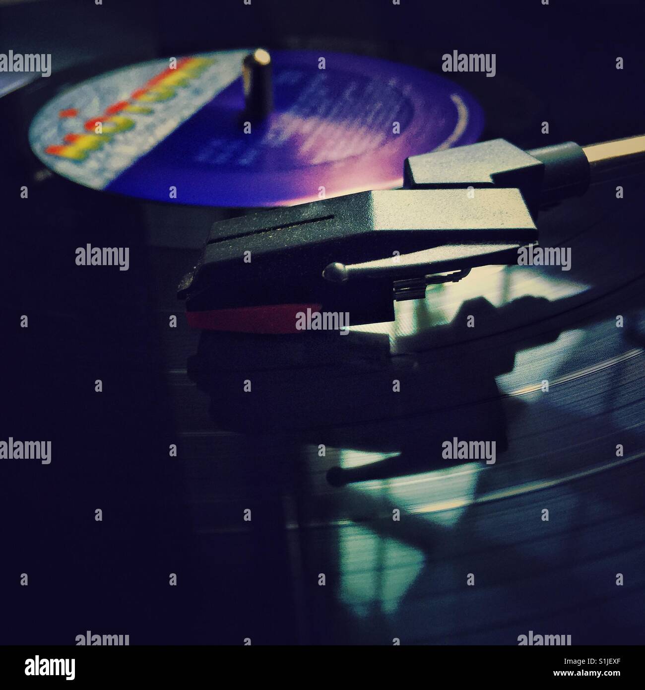 Needle reflects in vintage vinyl record playing on record player - Smartphone Captured Stock Image