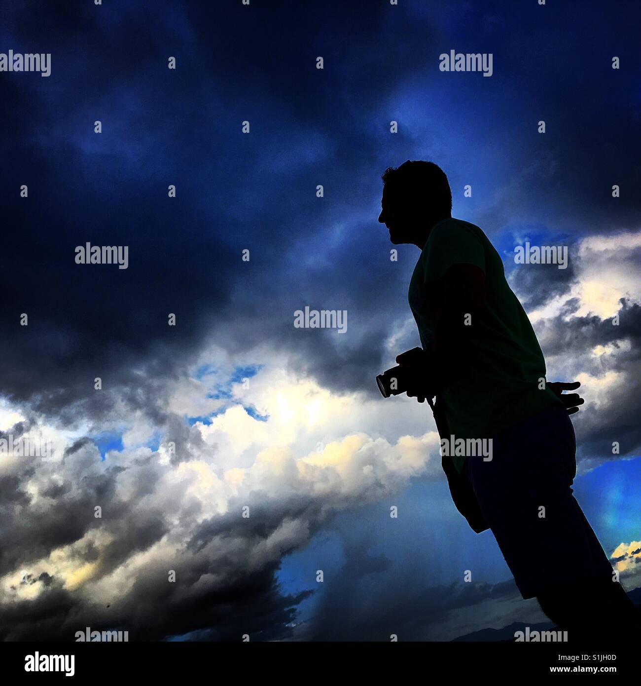 Silhouette of man with camera - Smartphone Captured Stock Image