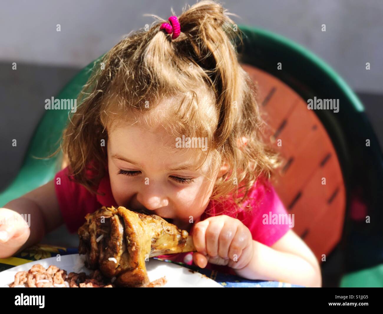 baby girl eating meat Toddler eating meat hi-res stock photography and images - Alamy