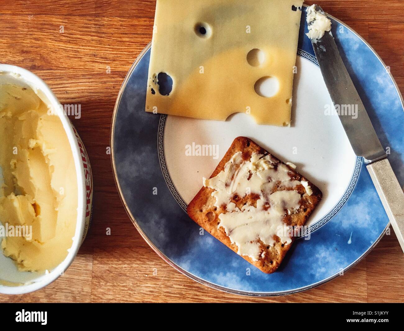 Jarlsberg sliced cheese and buttered cracker Stock Photo Alamy