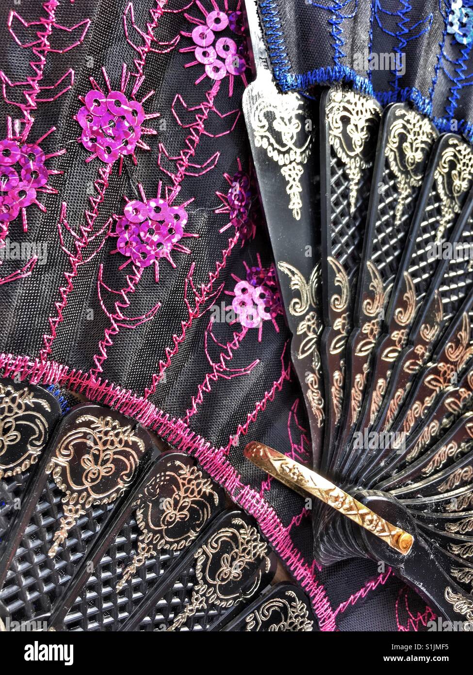 Modern decorated fans for sale in a Spanish market - Smartphone Captured Stock Image