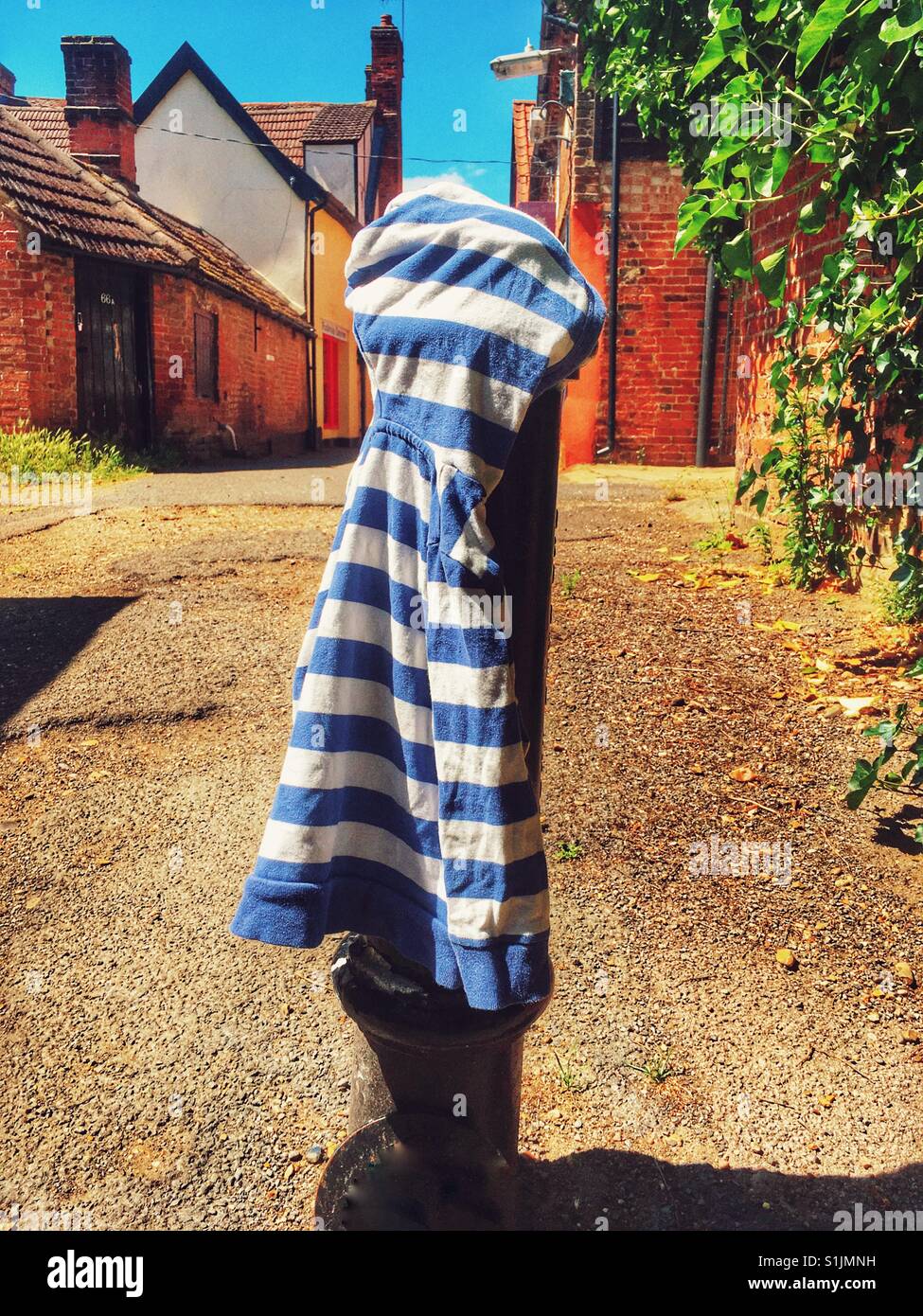 Child's hooded top lost and placed on post for owner to find, Woodbridge, Suffolk, UK. - Smartphone Captured Stock Image