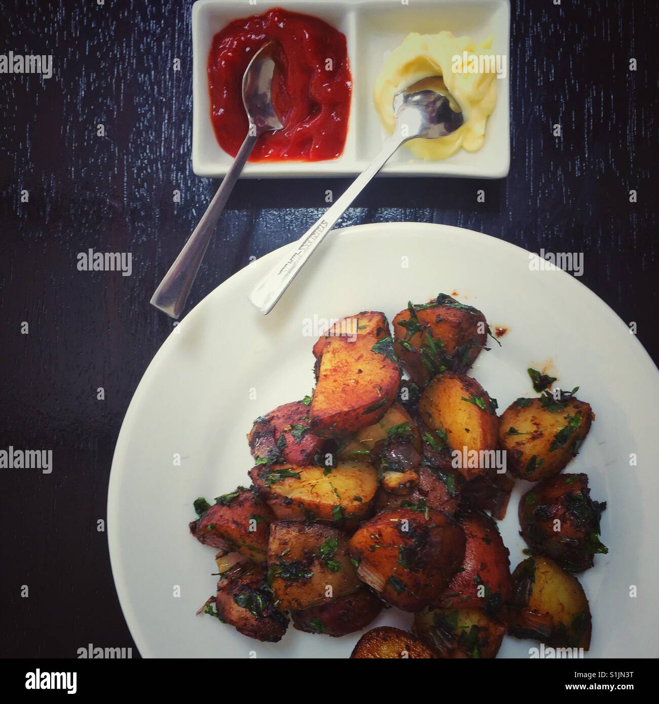 Roasted local Peruvian potatoes with homemade ketchup and mayo - Smartphone Captured Stock Image