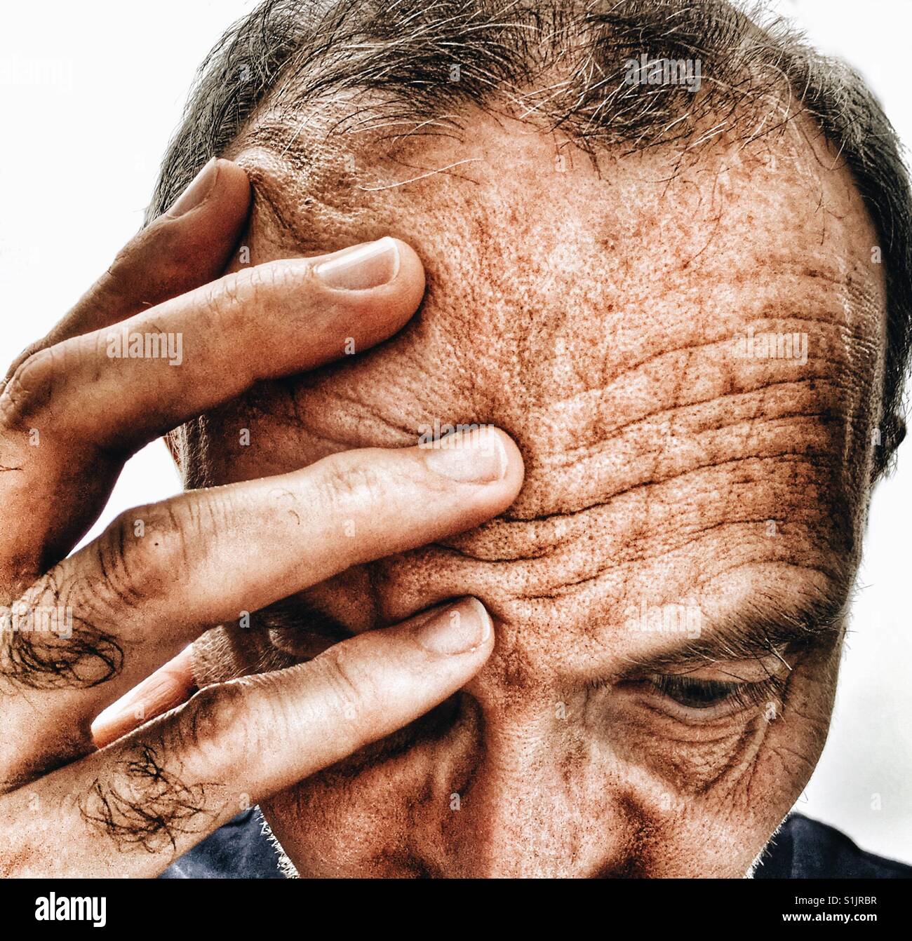 Close up of middle aged man with headache - Smartphone Captured Stock Image