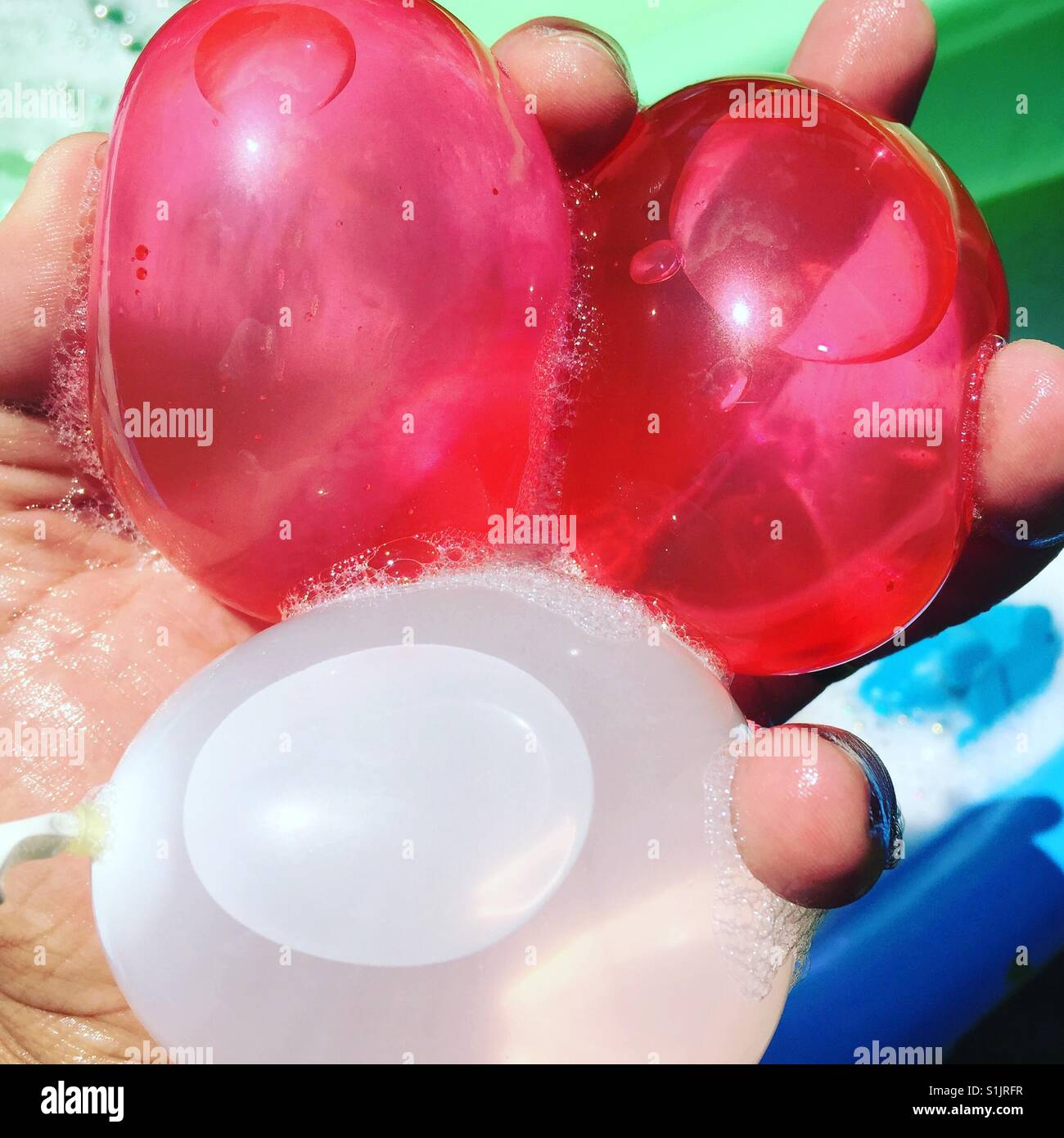 Holding some red and white balloons by K.R. Stock Photo