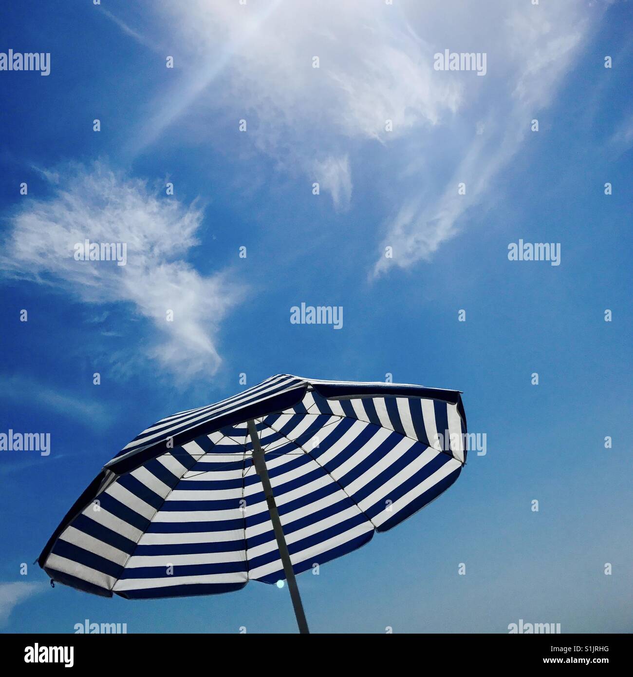 An umbrella and blue sky. Manhattan Beach, California USA. - Smartphone Captured Stock Image