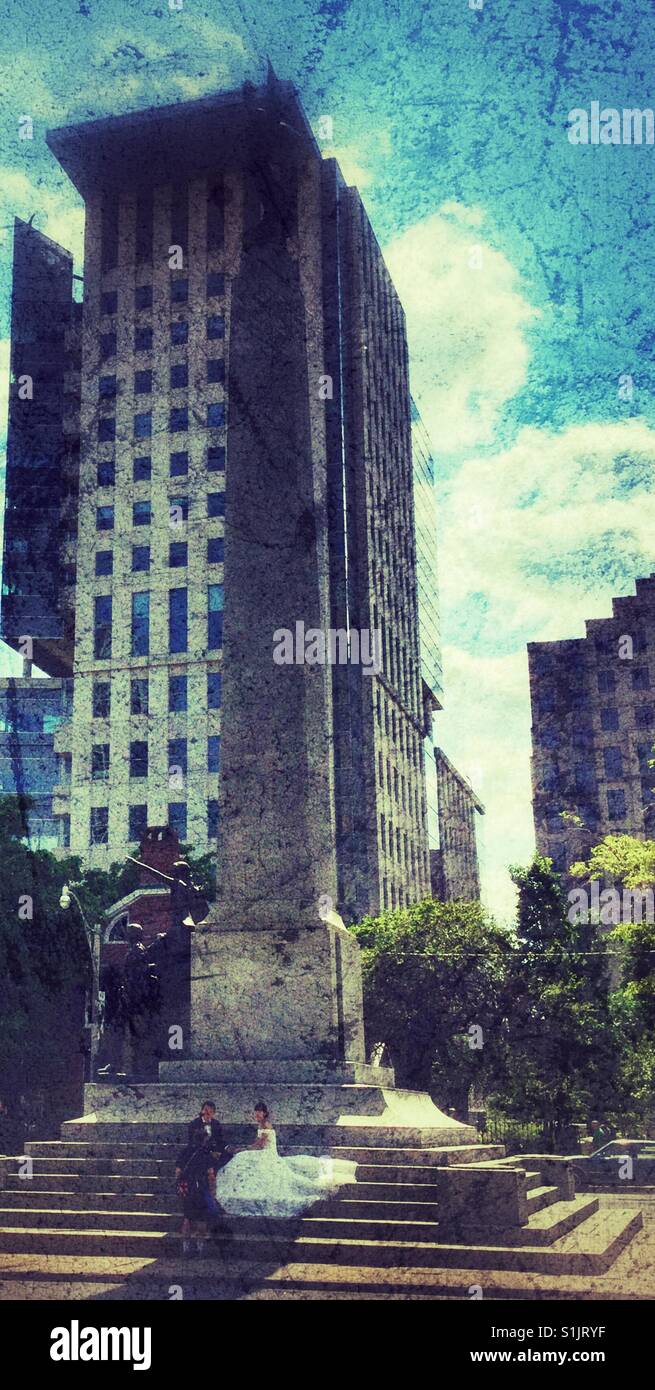 Wedding couple sitting on steps of a war memorial. - Smartphone Captured Stock Image