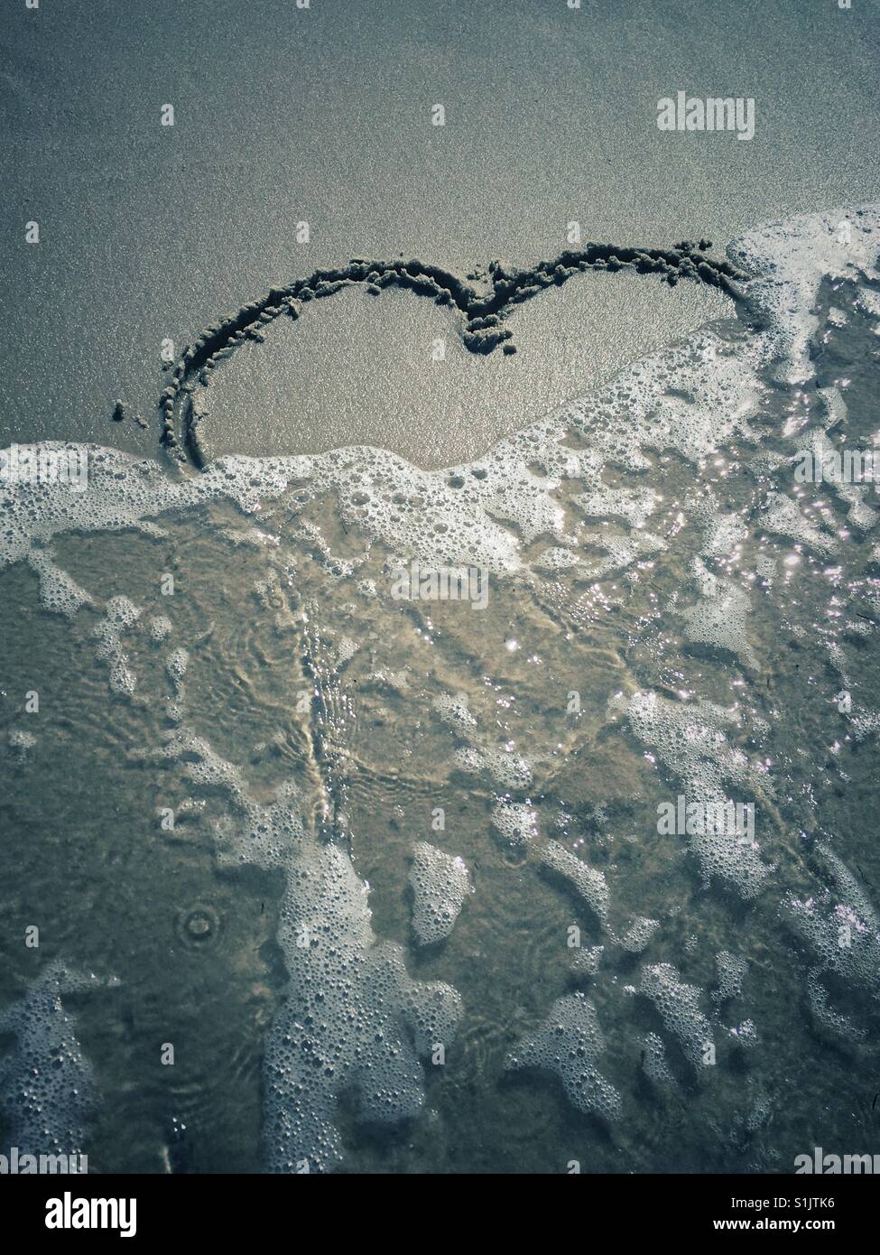 Sand Heart Washed Away By The Sea Stock Photo Alamy