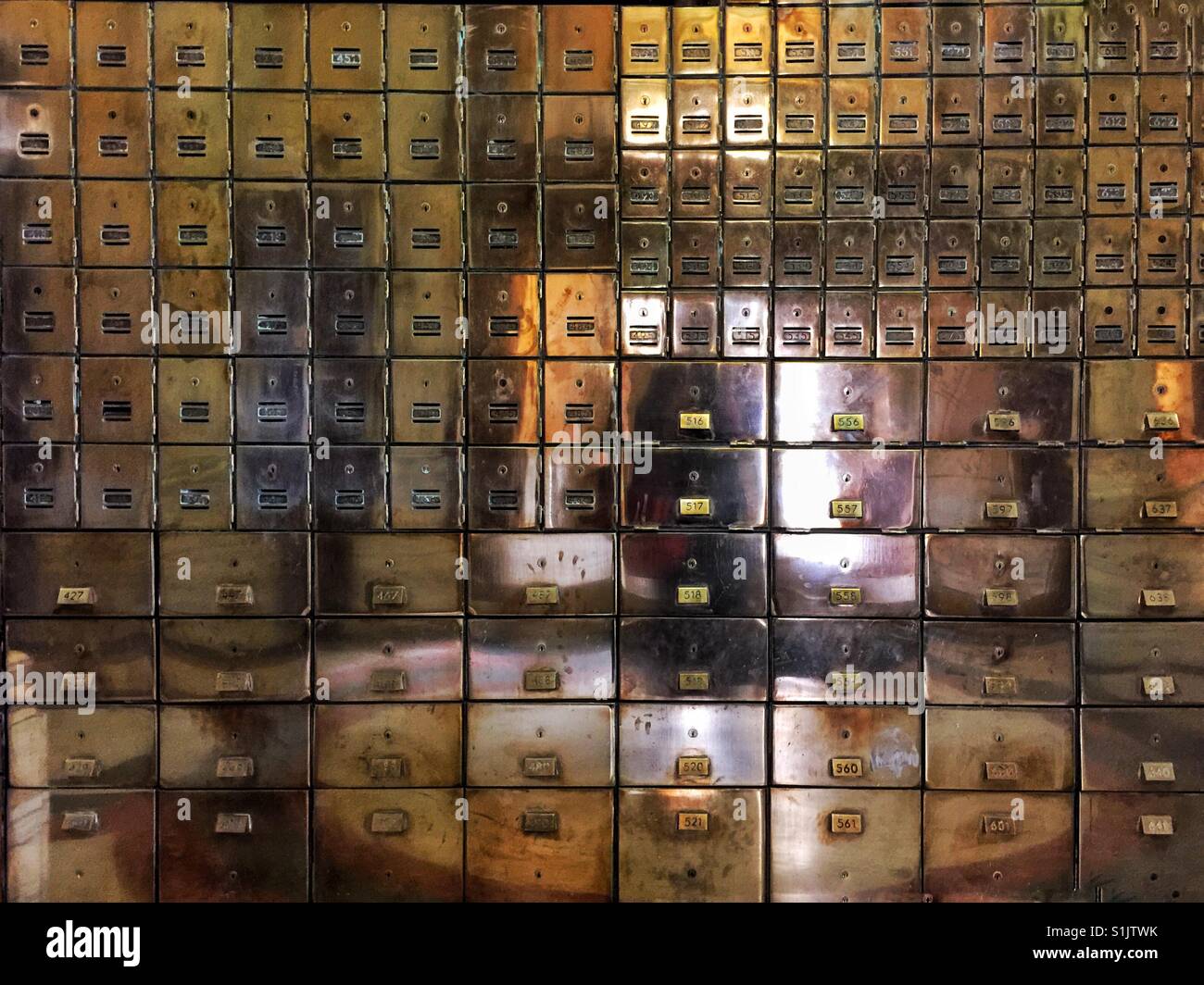 Reflection of the outside world in rows of shiny metal mail boxes in Post Office of city of Spokane, WA - Smartphone Captured Stock Image
