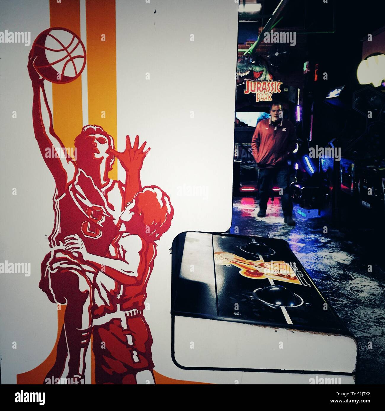 Man walking through video game arcade in Tacoma WA - Smartphone Captured Stock Image