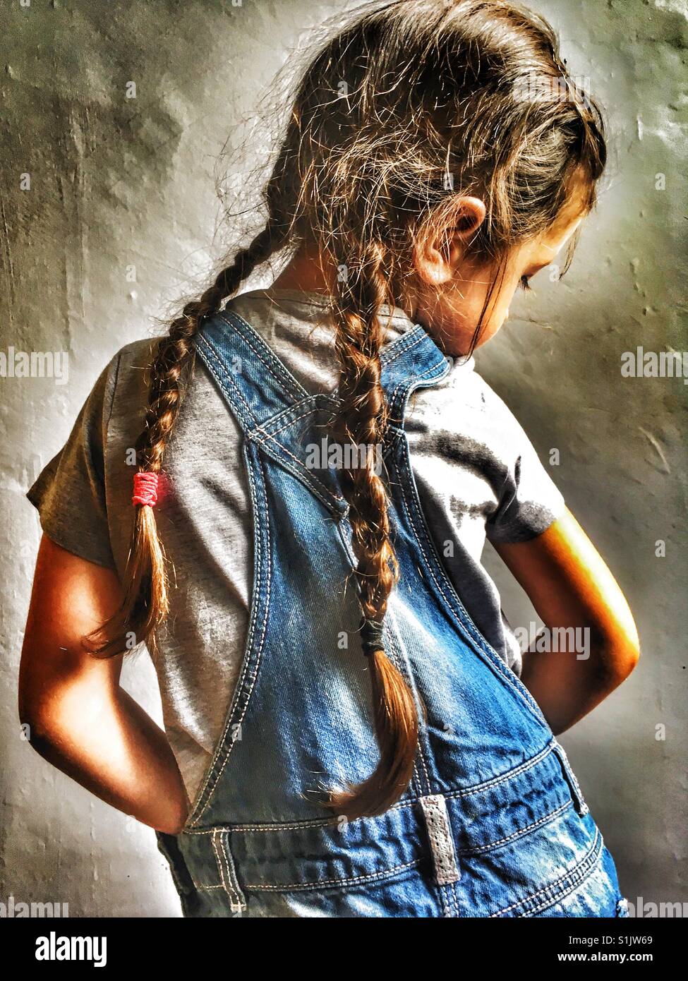 Denim dungarees and pigtails - Smartphone Captured Stock Image