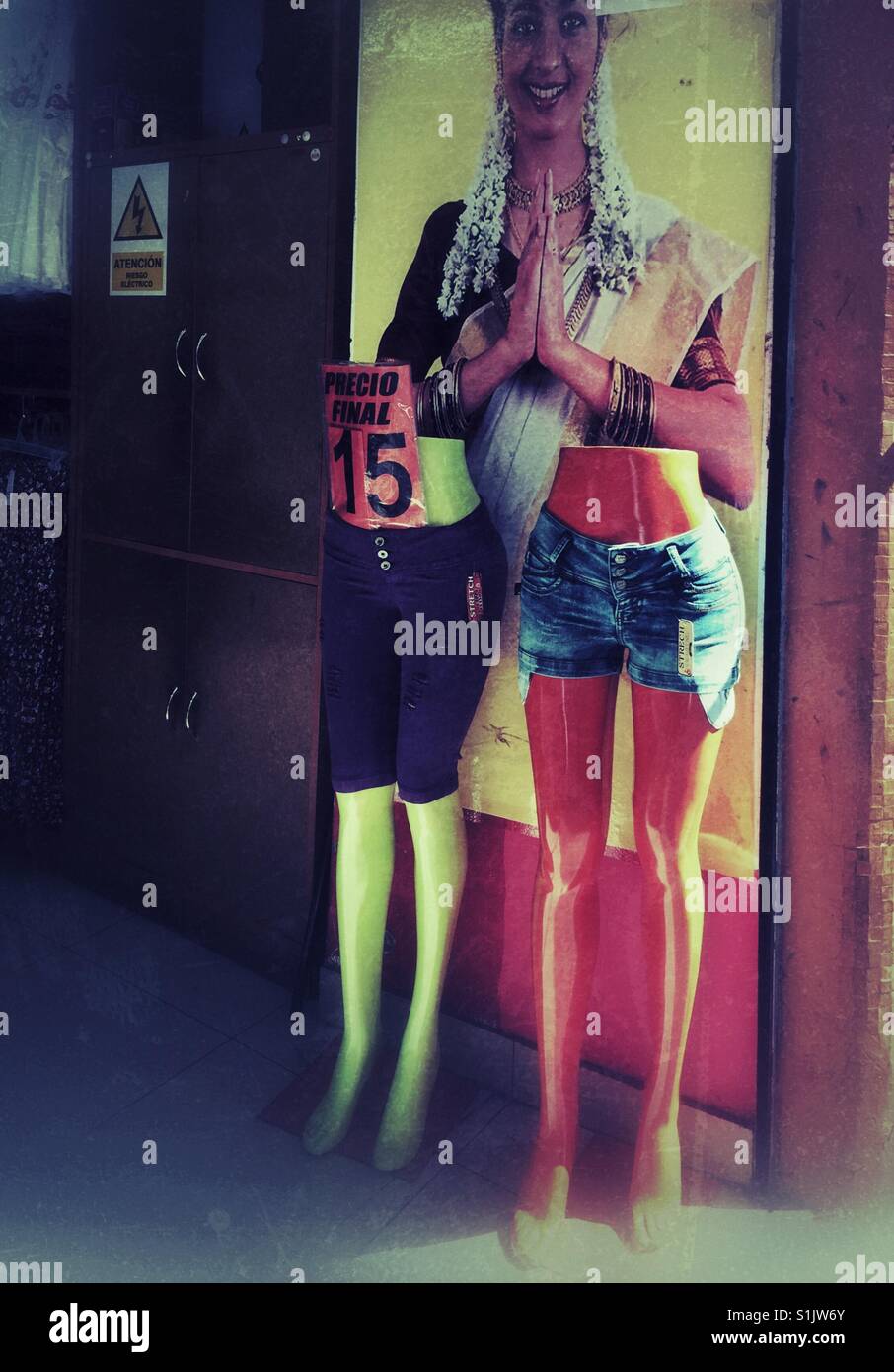 Namaste poster and headless manikins at the entrance to clothing shop in Lima, Peru - Smartphone Captured Stock Image