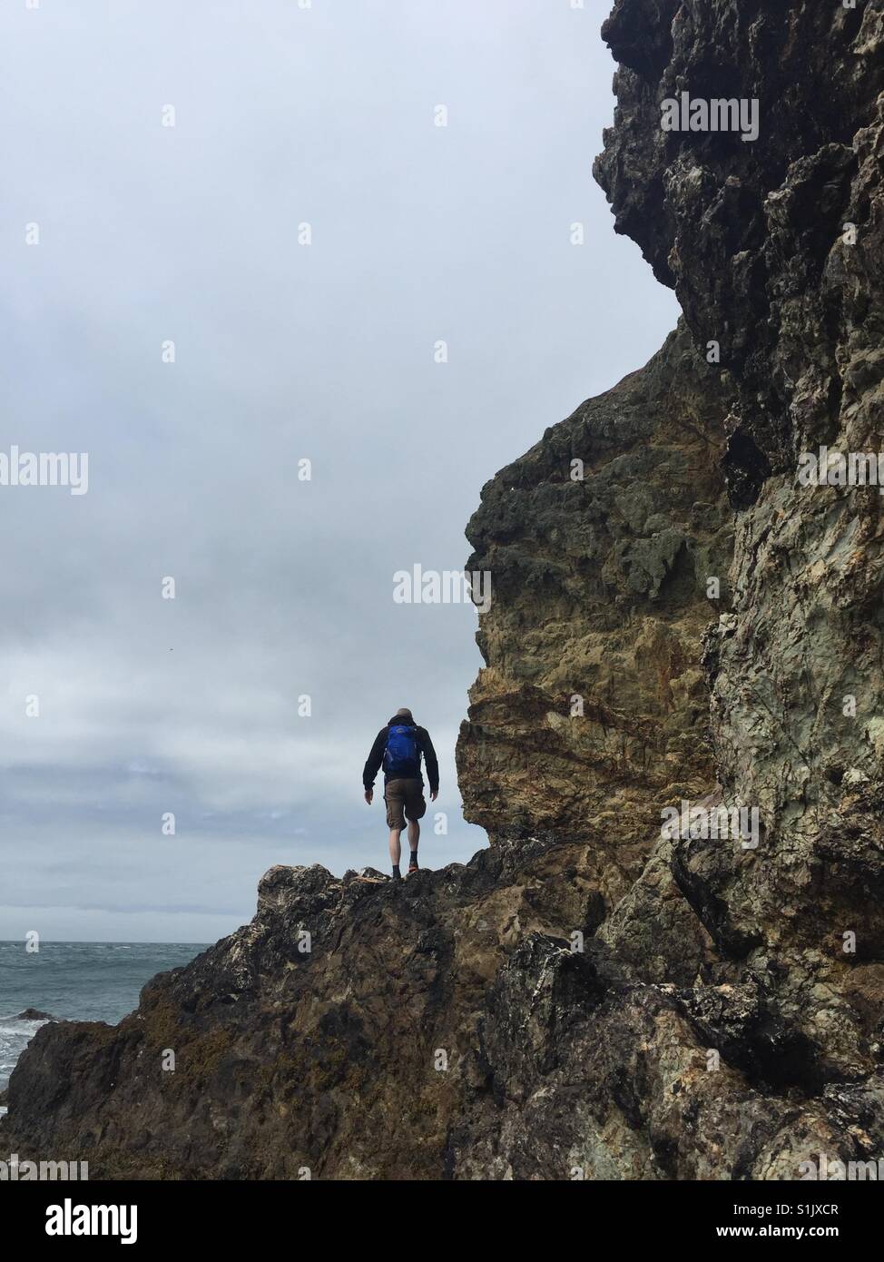 Climbing over the rocks at Ynys y Fydlyn, Anglesey, North Wales, United Kingdom - Smartphone Captured Stock Image