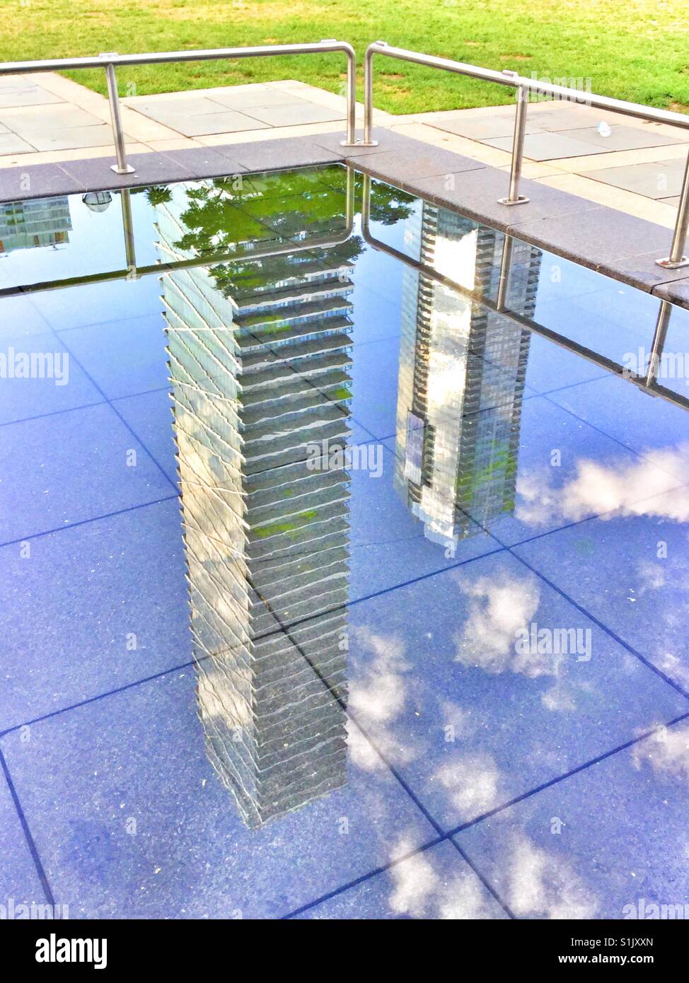 City condos reflected in a pond. - Smartphone Captured Stock Image