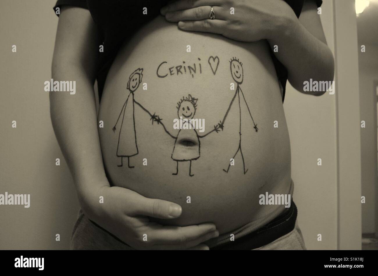 Pregnant women with family drawing on belly Stock Photo - Alamy