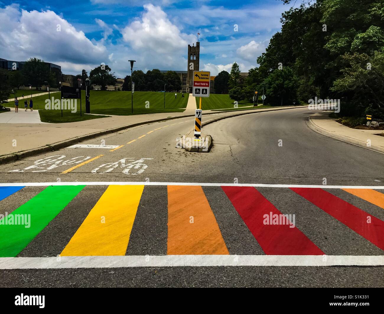 Preparing for Pride Parade: crosswalk painted in LGBTQ+ colours at a college campus, London, Ontario, Canada - Smartphone Captured Stock Image