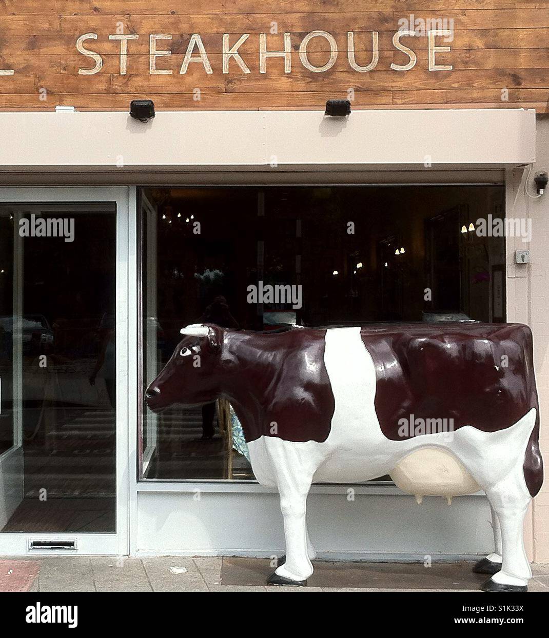 Steakhouse with model cow outside. Stock Photo