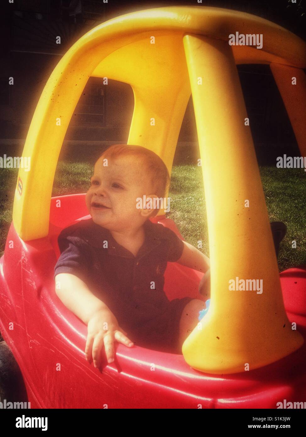 Baby in toy car Stock Photo Alamy