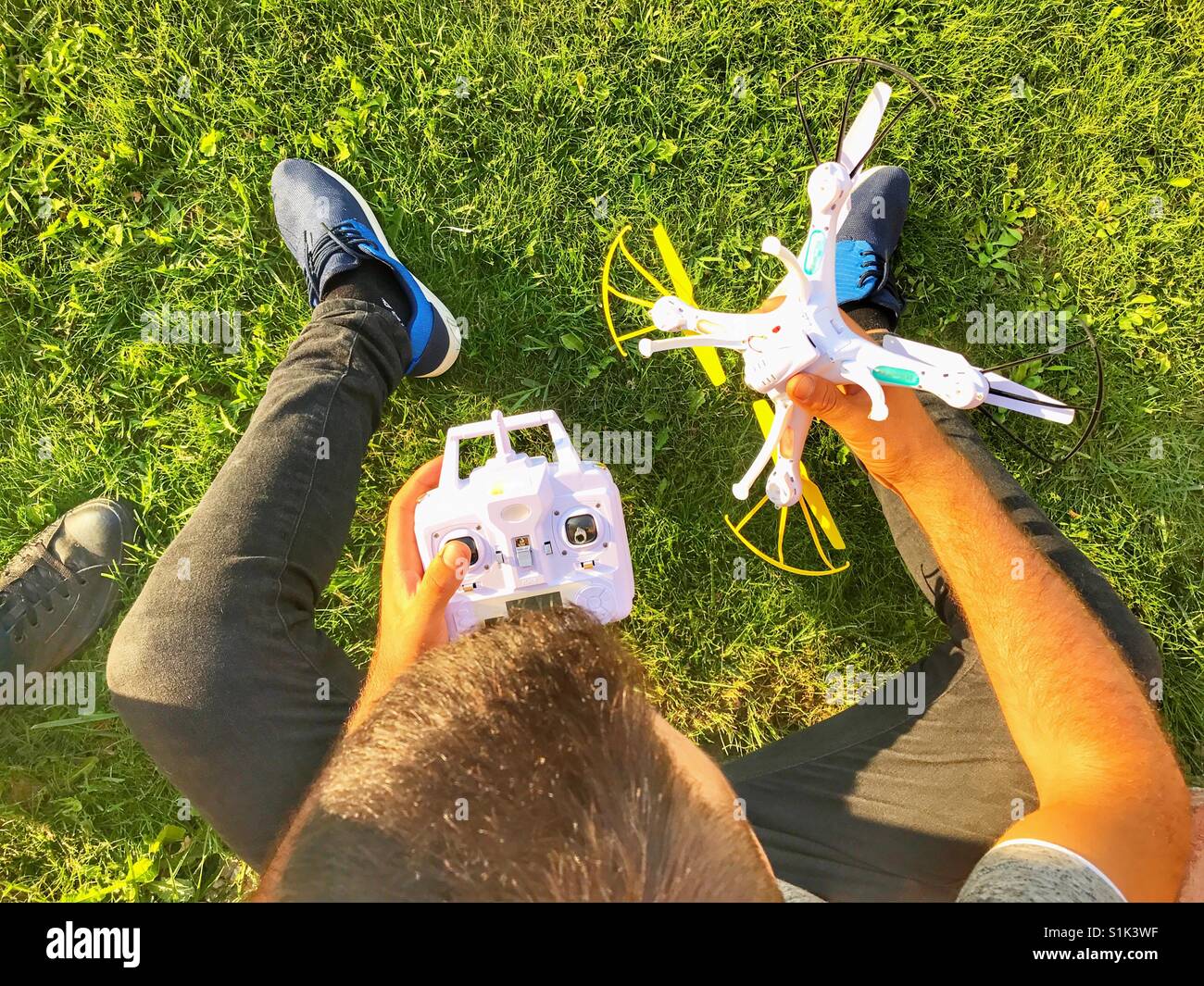 Young man with drone and controller - Smartphone Captured Stock Image