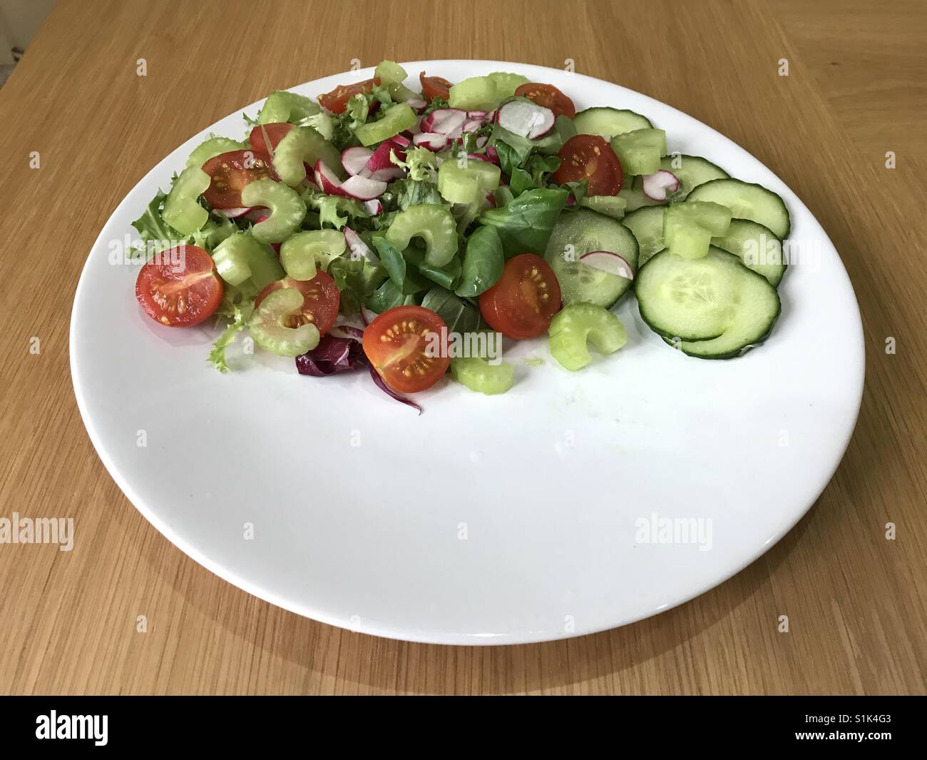 A heathy fresh mixed salad is a versatile accompaniment to meat, fish or other main elements of the meal. What will you serve with it? - Smartphone Captured Stock Image