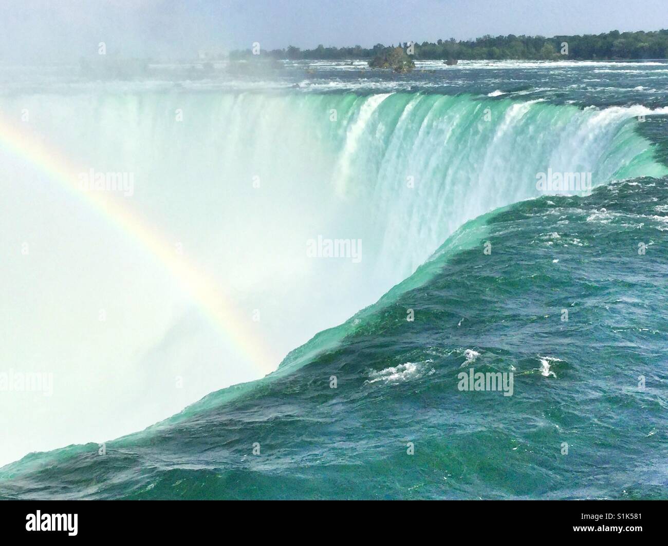 A rainbow rises out of the Falls. - Smartphone Captured Stock Image
