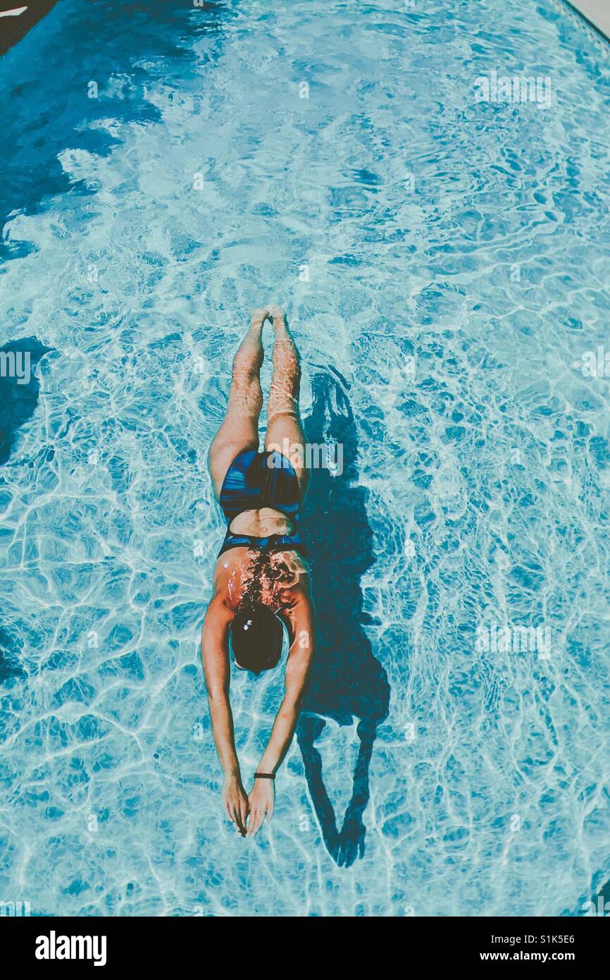 Woman swimming in outdoor swimming pool. Space for copy. - Smartphone Captured Stock Image