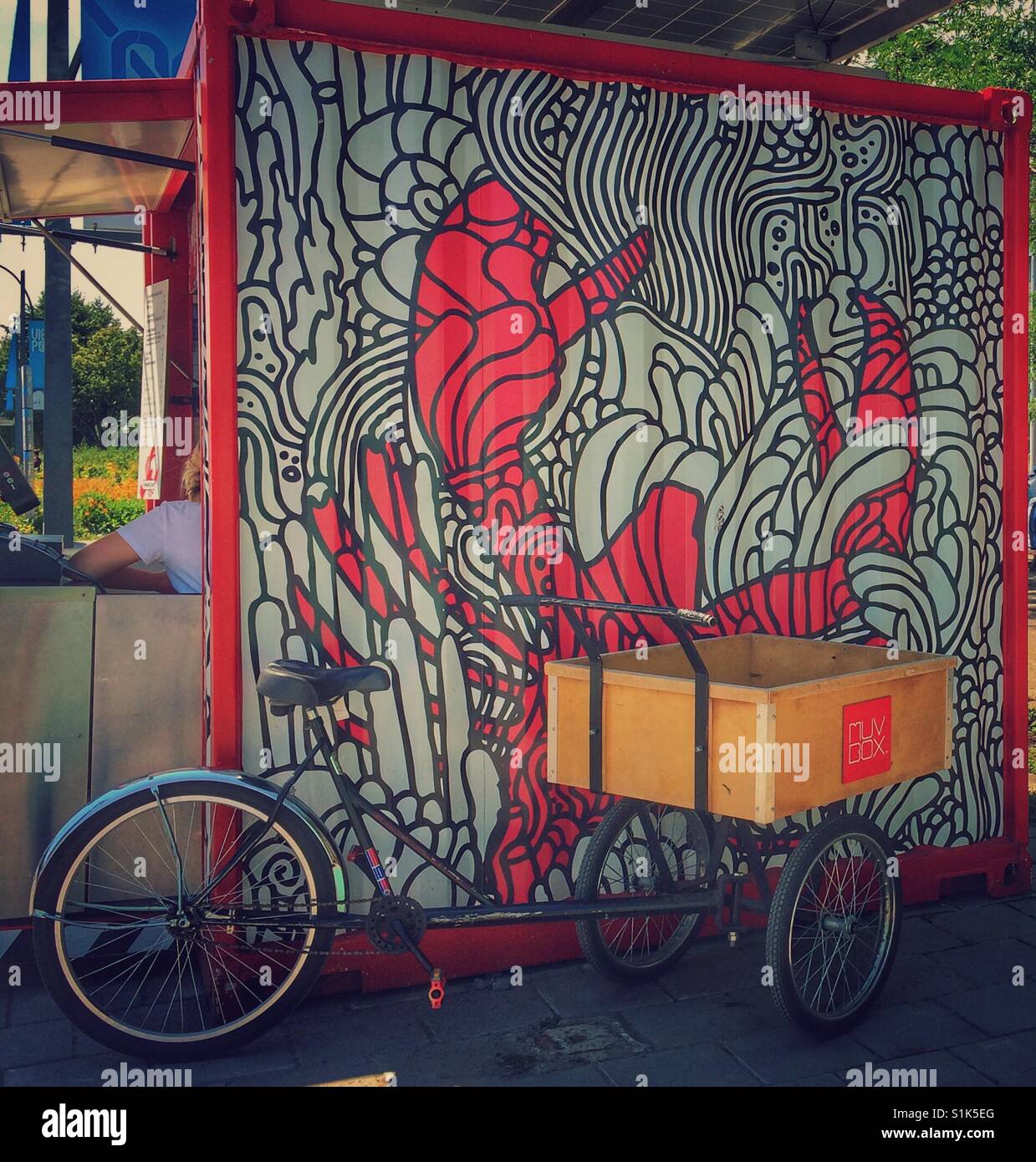 Fast food restaurant wall design with bicycle in front. Stock Photo