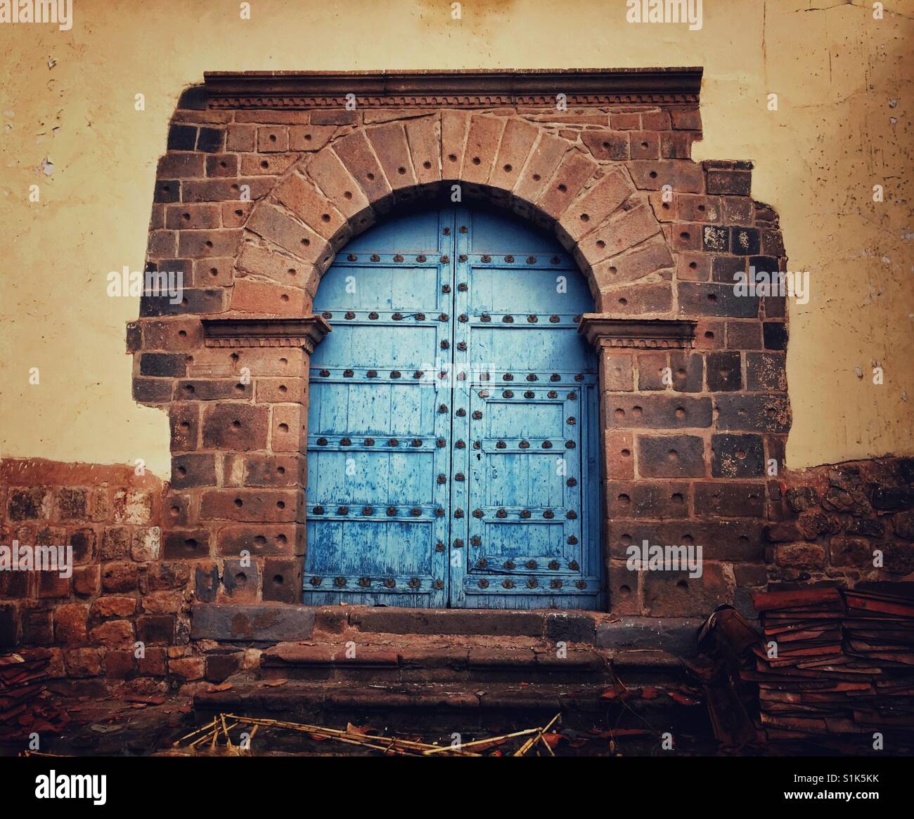 Massive Cobalt arched door in Cusco, Peru Stock Photo