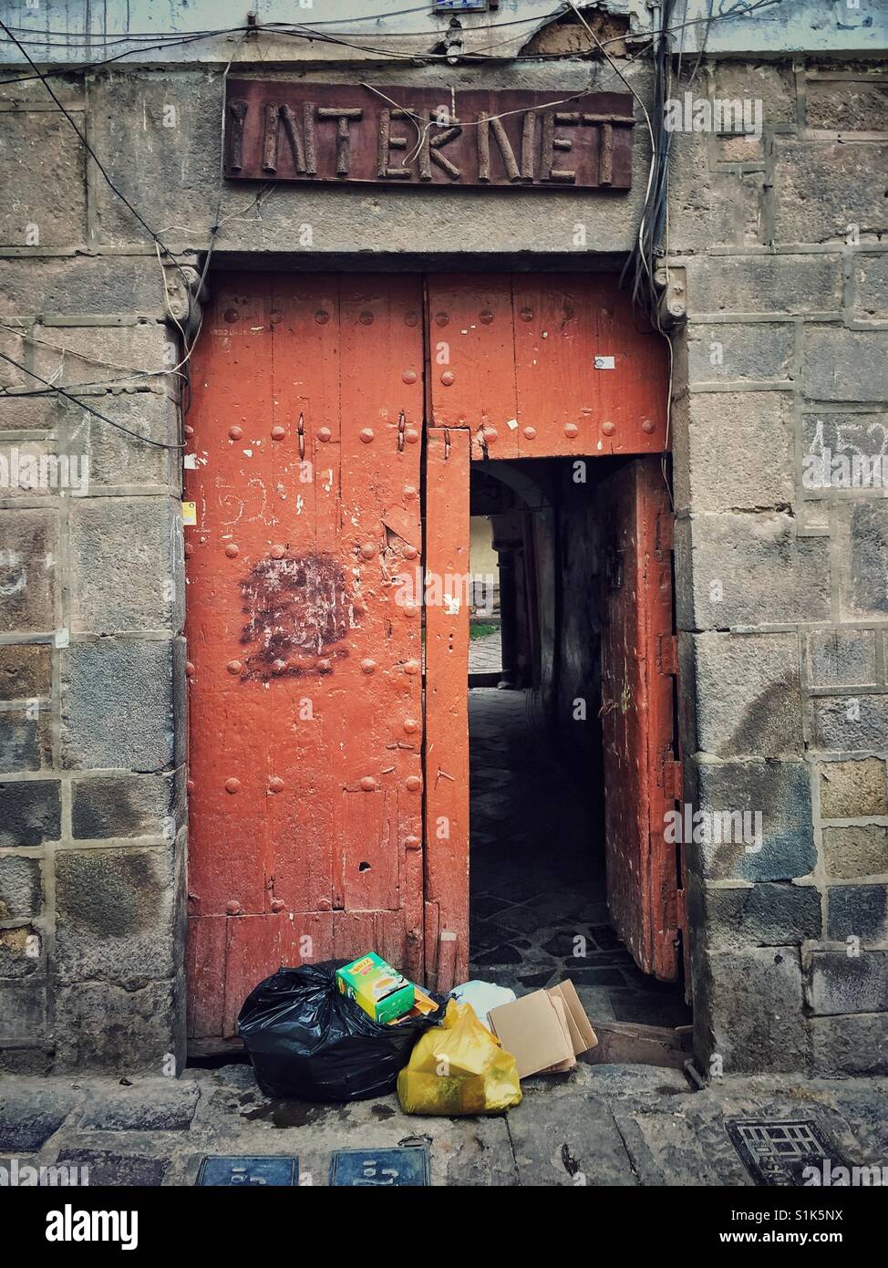 Analog Internet Sign Made Of Sticks Above Heavy Double Door And Trash Stock Photo Alamy
