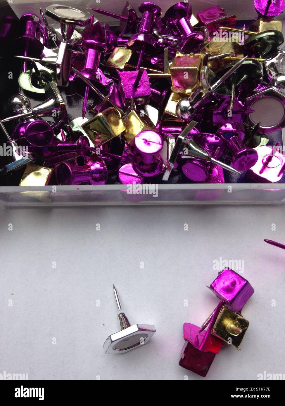 An assortment of shiny metallic pushpins Stock Photo
