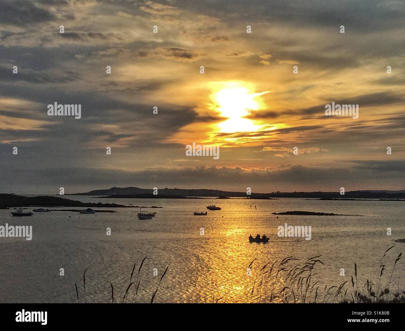 Sun setting over sea on Rhosneigr beach in summer - Smartphone Captured Stock Image