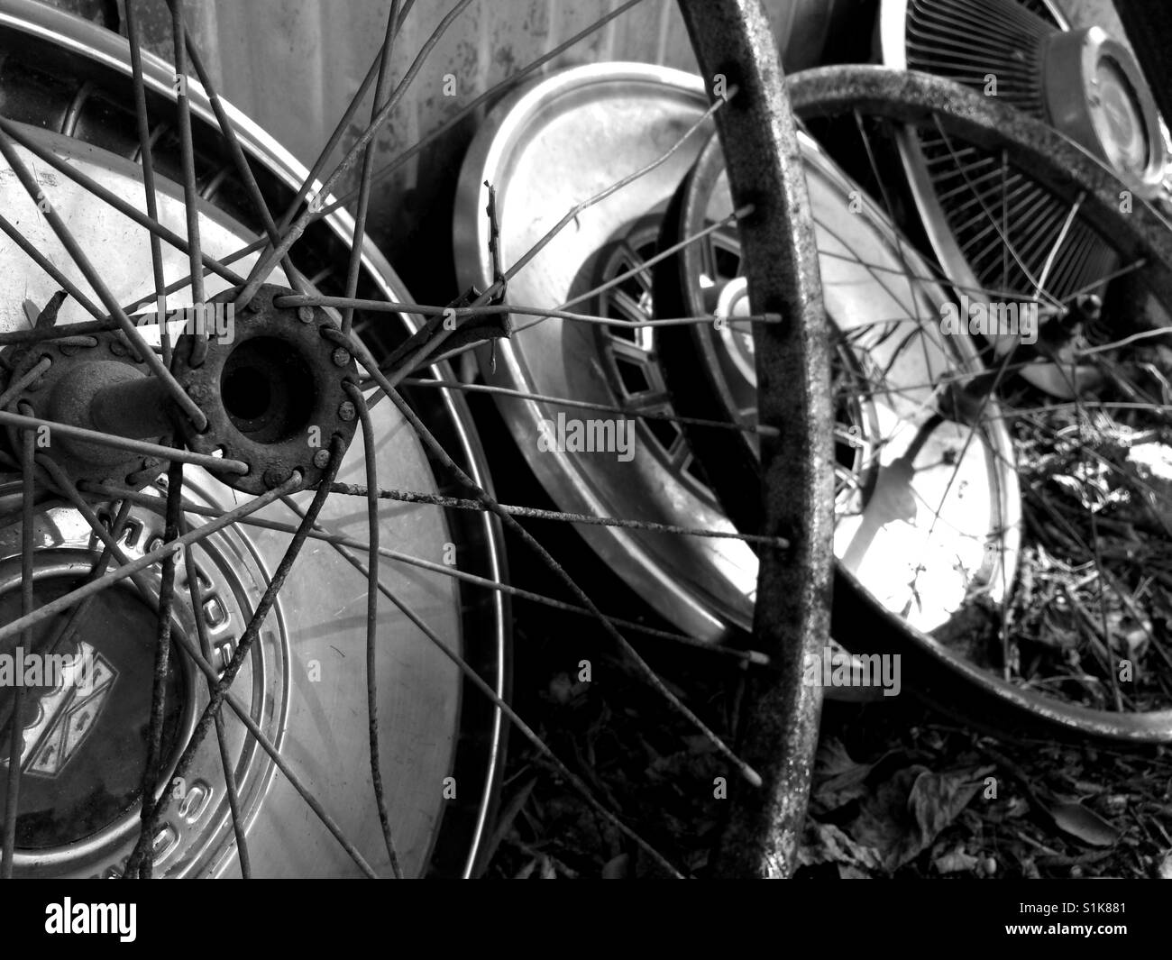 Wheels of Time:  An arrangement of antique wheels and hubcaps from the 1960's and 1970's. Stock Photo