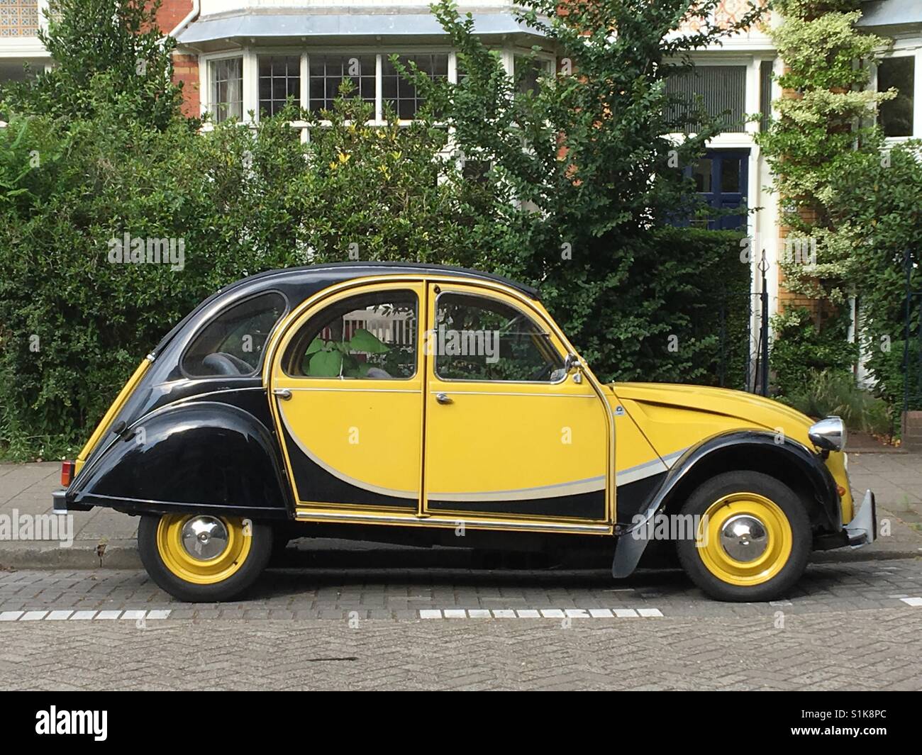 Vintage yellow car in The Hague Stock Photo - Alamy