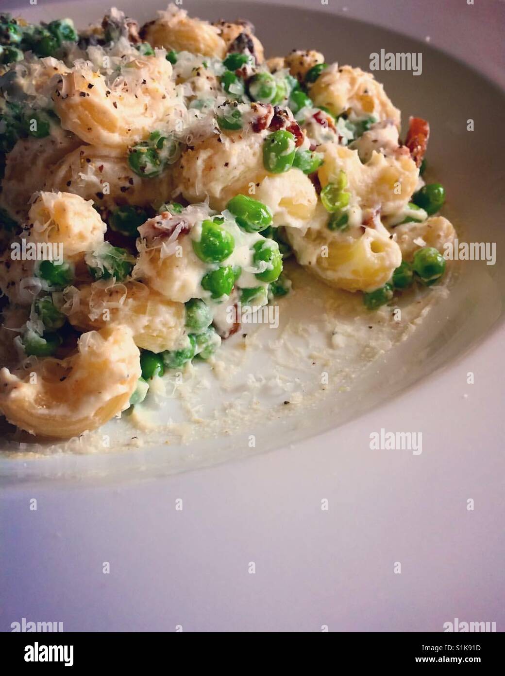 Pasta with ricotta, peas, and bacon Stock Photo Alamy