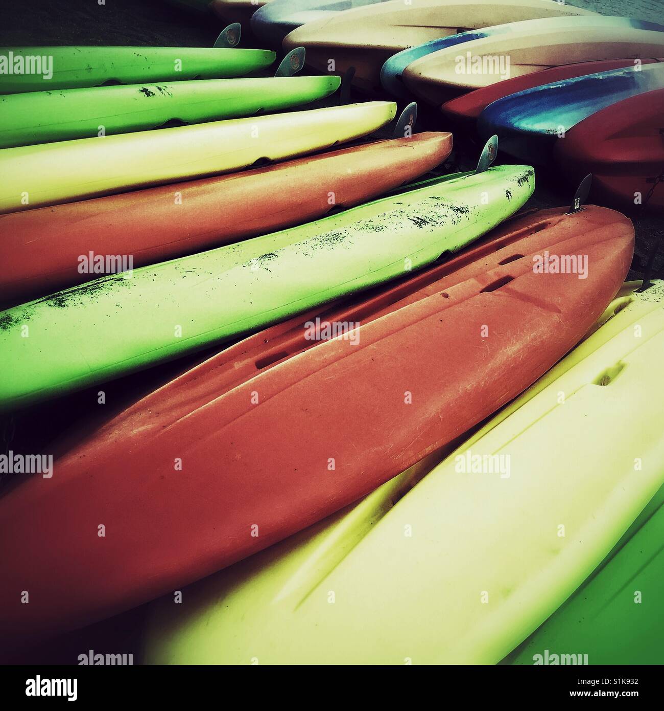 Colorful overturned kayaks for rent on the beach - Smartphone Captured Stock Image