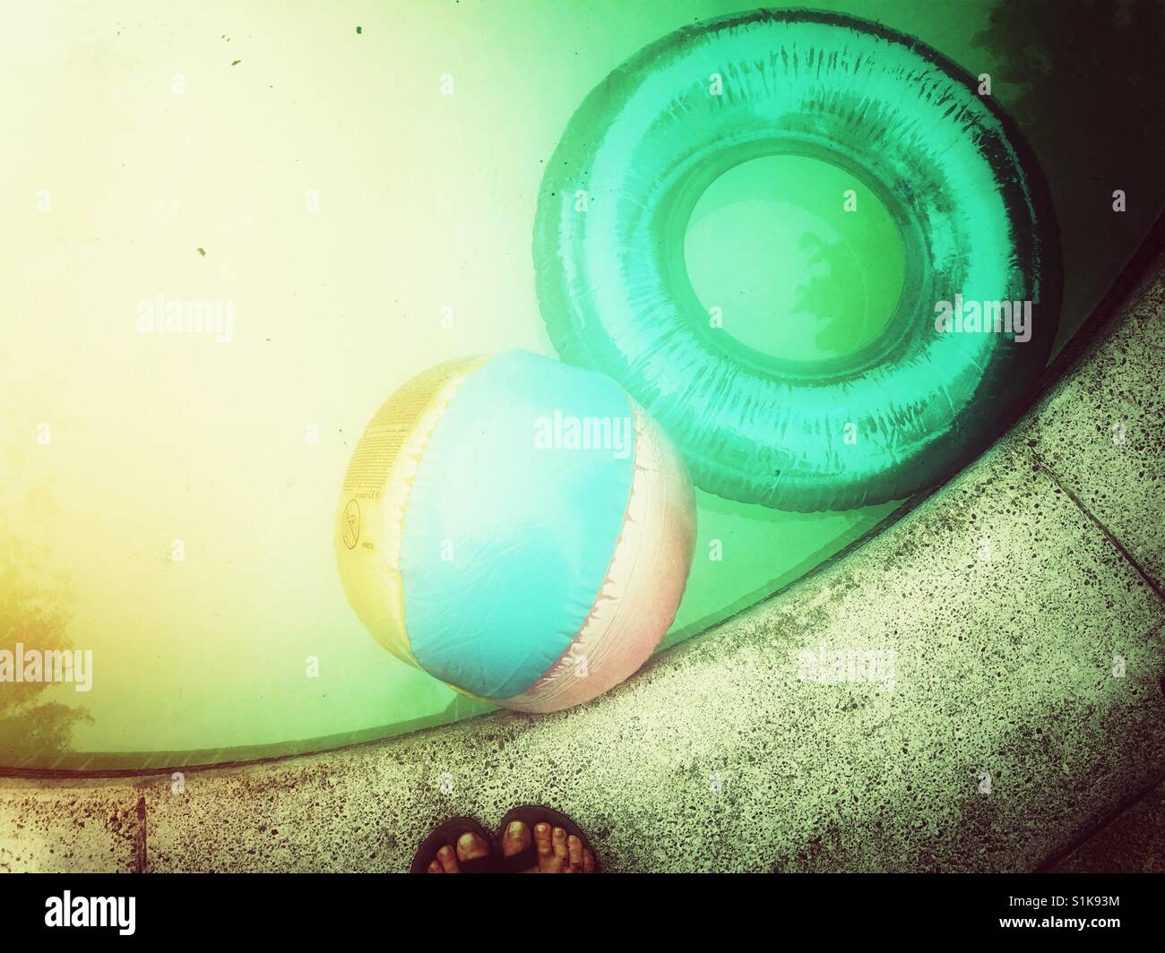 Inflatable ball and ring left in the pool - Smartphone Captured Stock Image