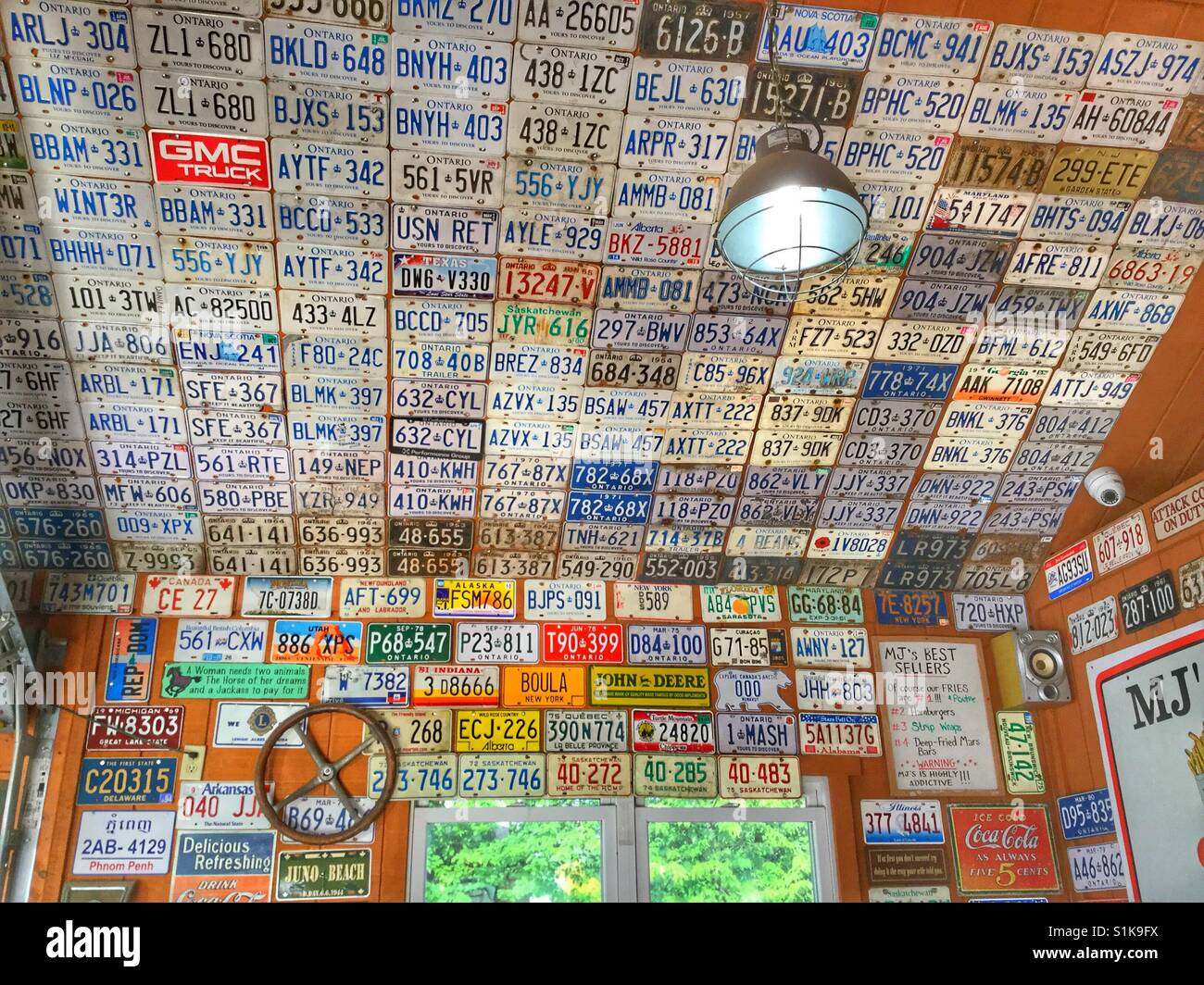 A wall of old license plates. Stock Photo