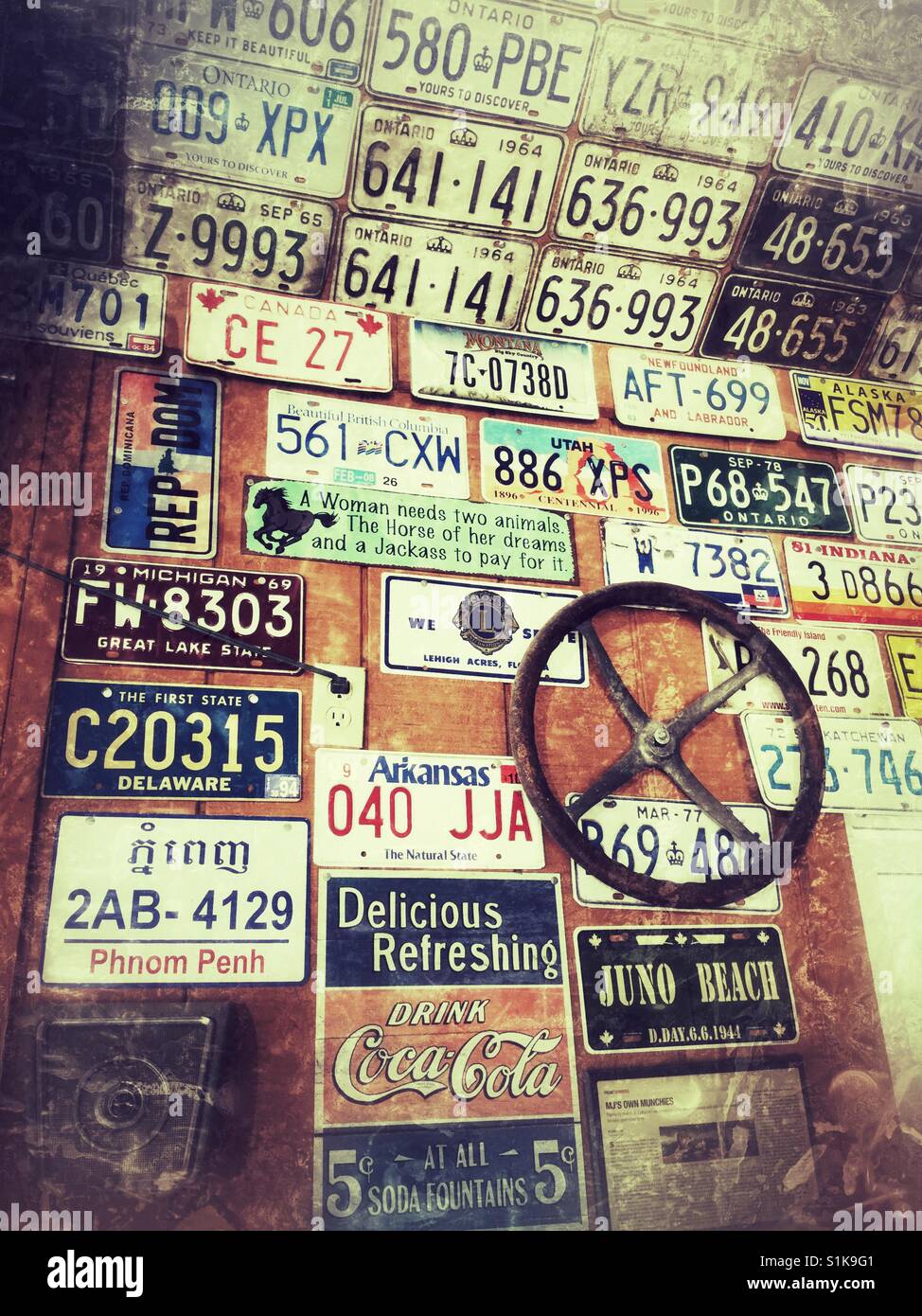 Old license plates used as wall art. Stock Photo