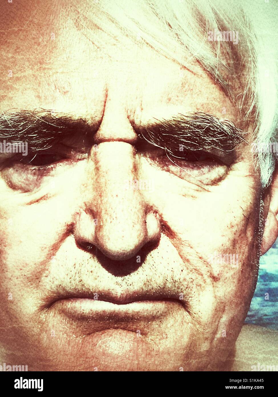 Senior man, rather grumpy - Smartphone Captured Stock Image