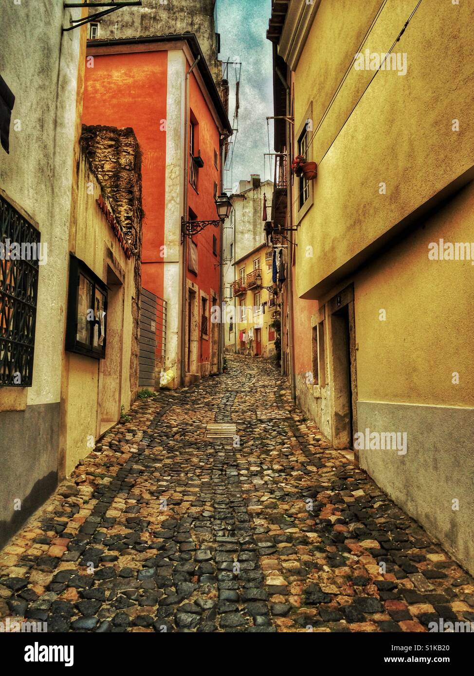 Narrow cobblestone street in Lisbon, Portugal Stock Photo - Alamy