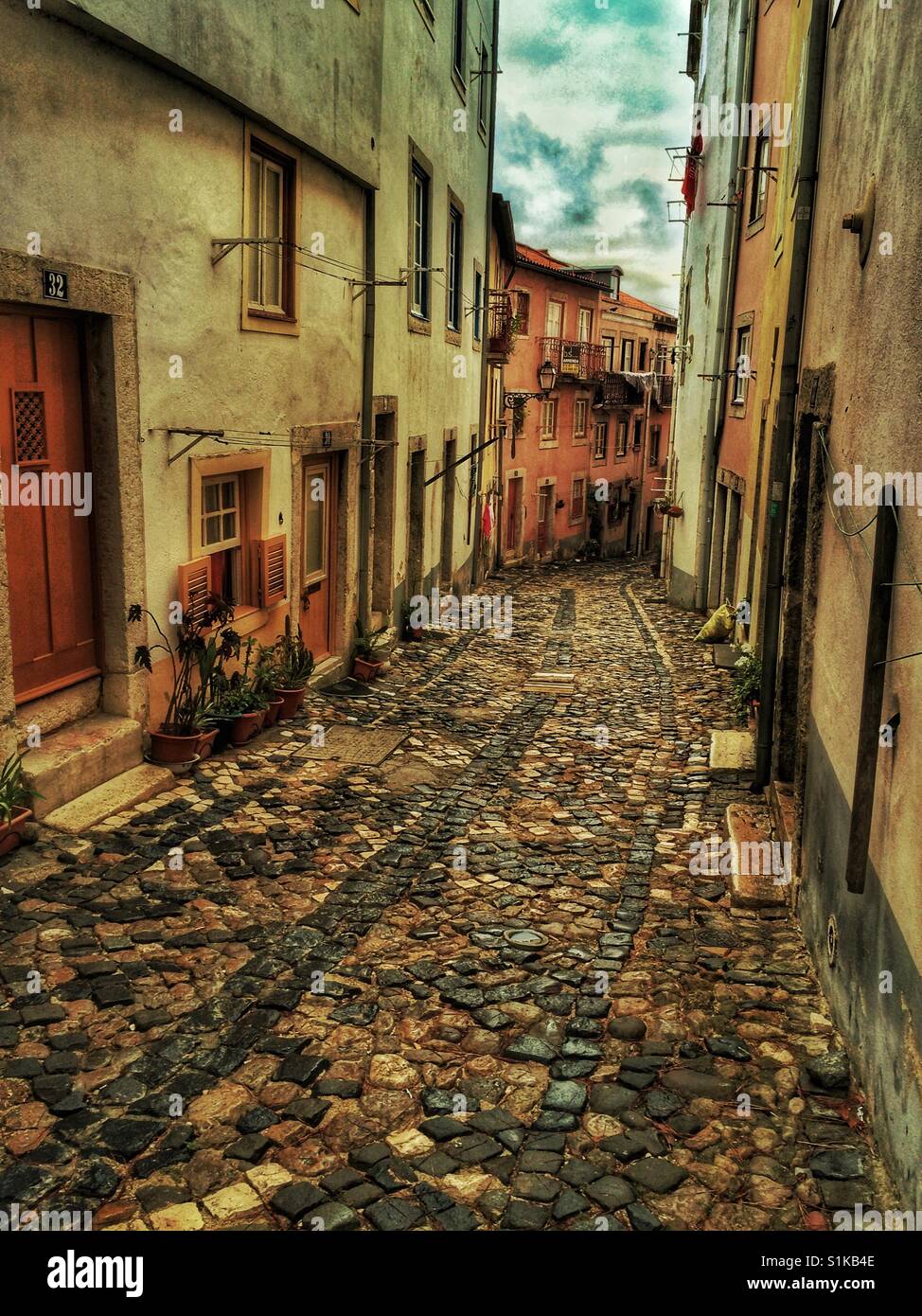 Narrow cobblestone street in Lisbon, Portugal Stock Photo - Alamy