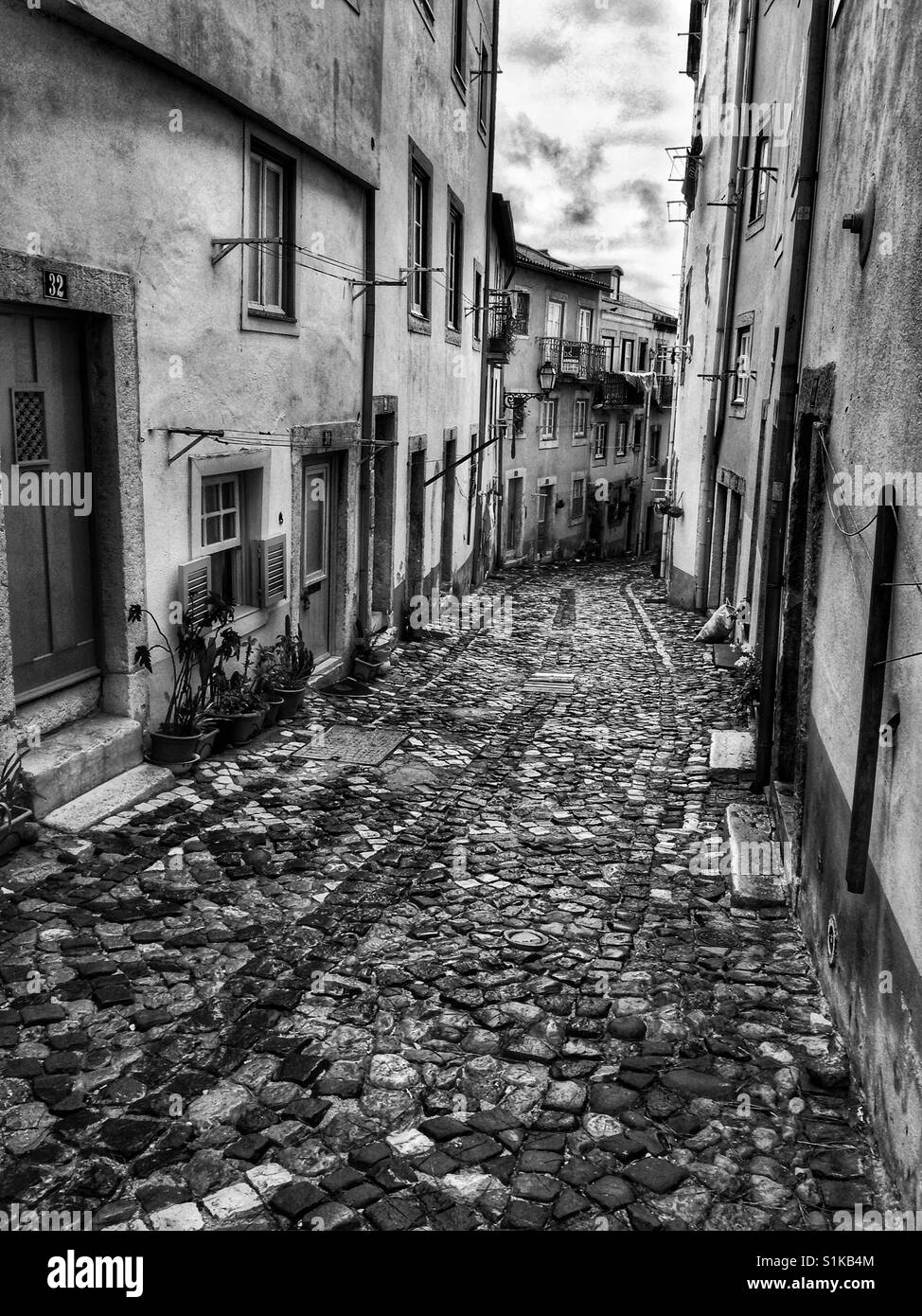 Narrow cobblestone street in Lisbon, Portugal. Stock Photo