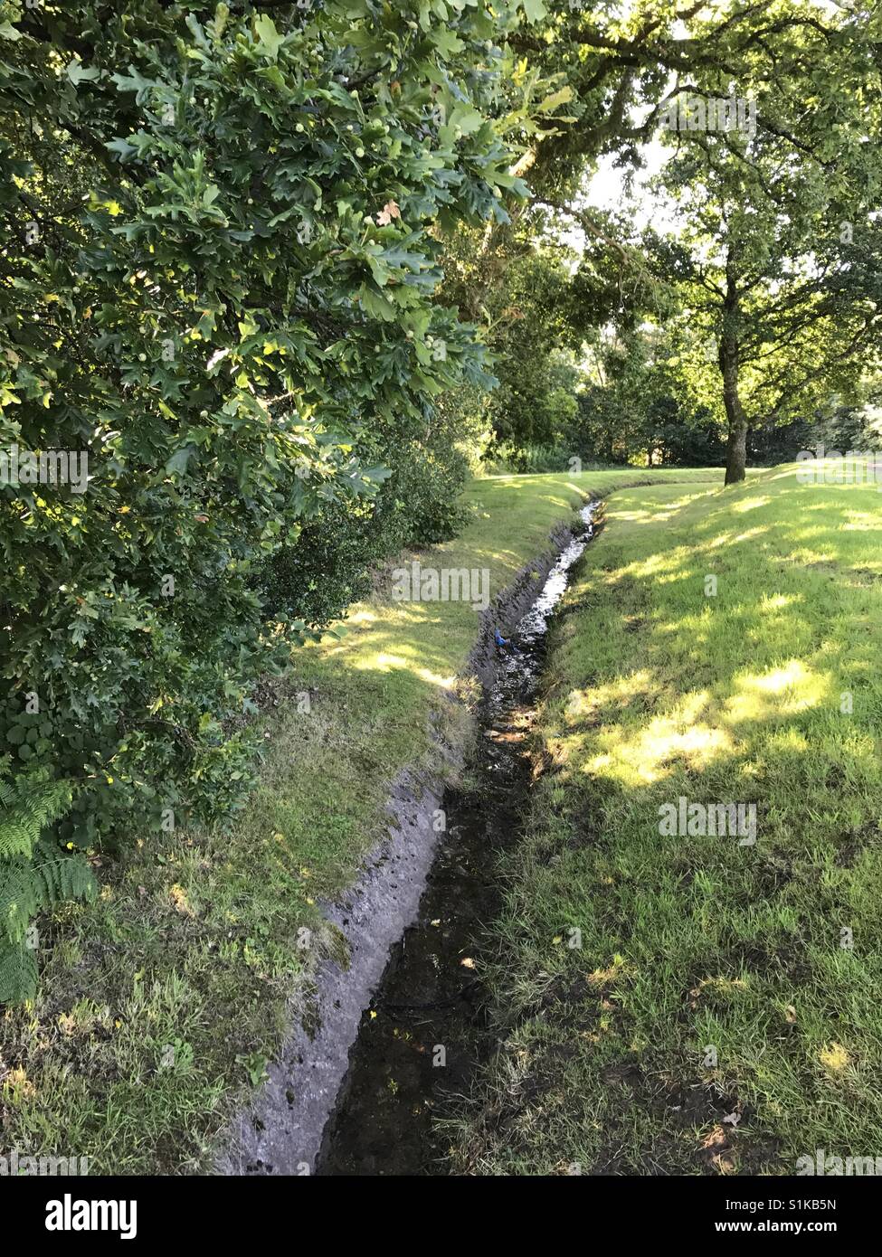 Drainage channel for water run-off in a public park - Smartphone Captured Stock Image