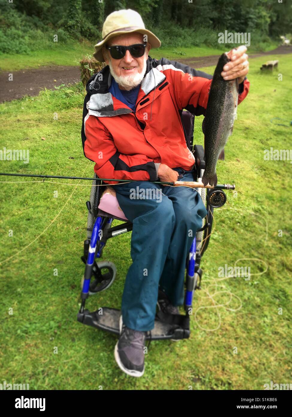 Disabled man fishing Stock Photo Alamy