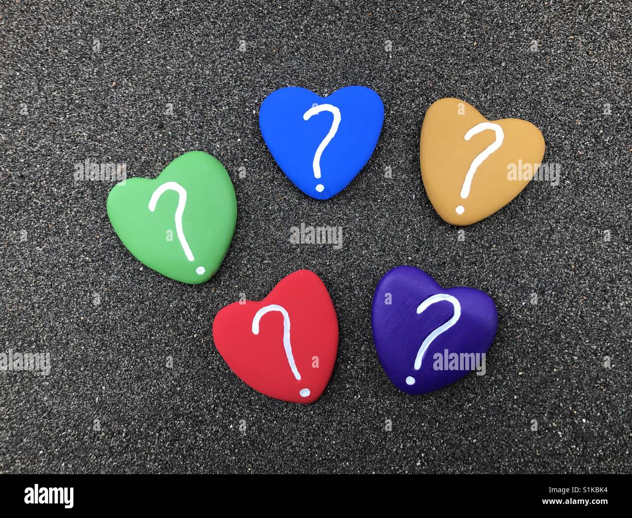 Question marks with multicolored heart stones - Smartphone Captured Stock Image